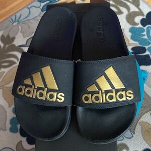 Adidas used comfort slides.size 6. Need a new home. Black with gold letters.